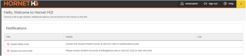The image shows two warning messages for the HornetHQ main screen: one for the Health Office Hold and one for the Student Account Hold. Both contain the contact details for their respective office.